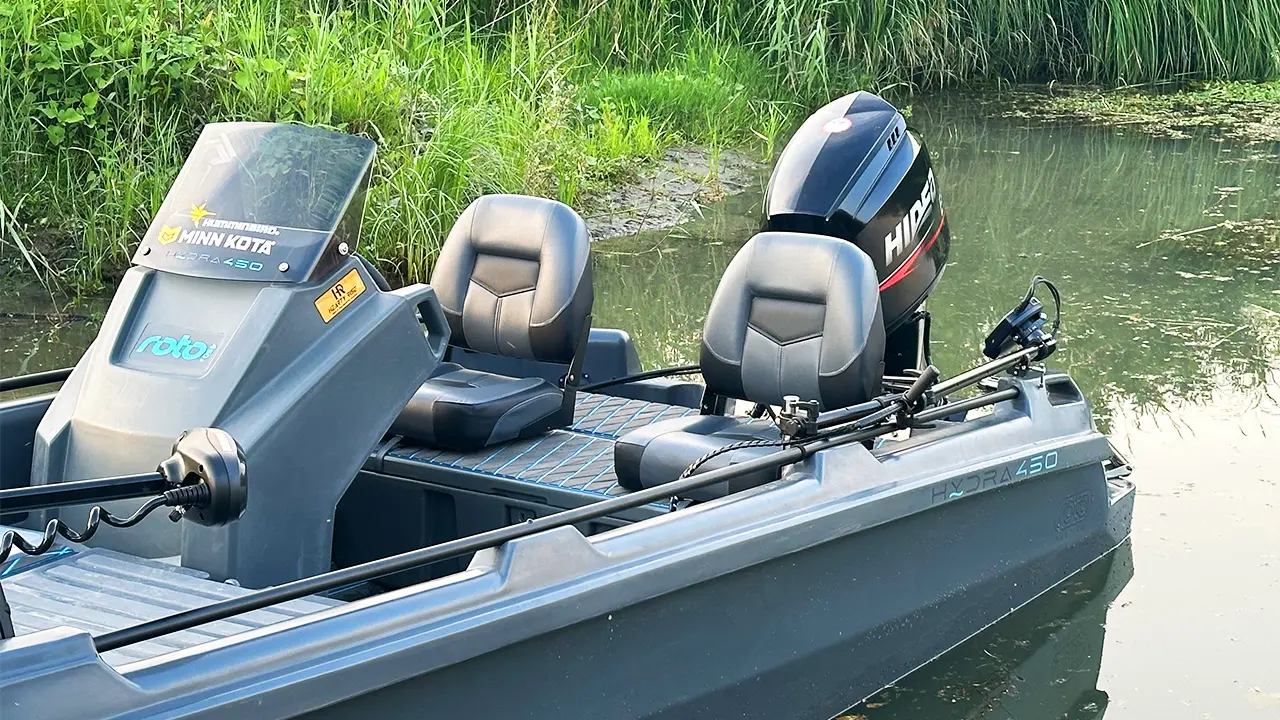 The Hydra 450 Fishing boat docked on a clear lake.
