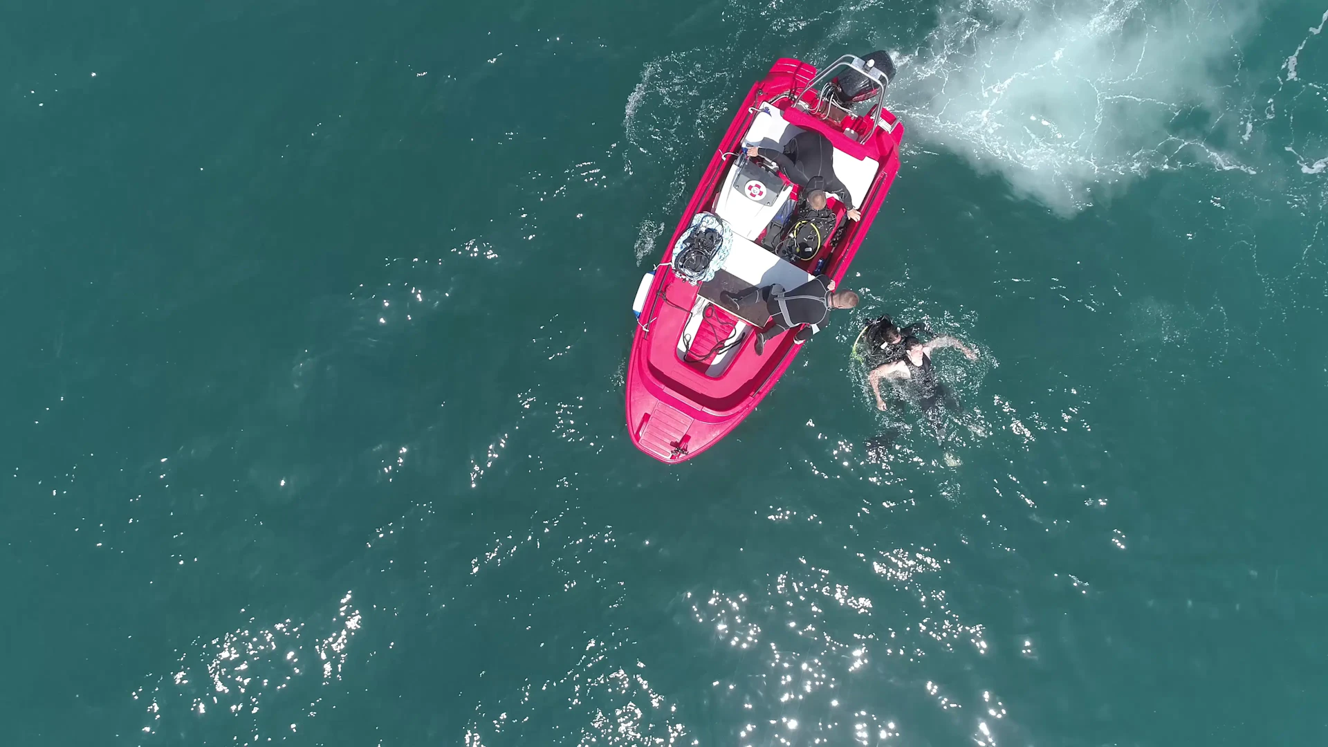 Hydra 450 rescue boat with a team of rescuers performing a sea rescue, recovering a diver from the water.