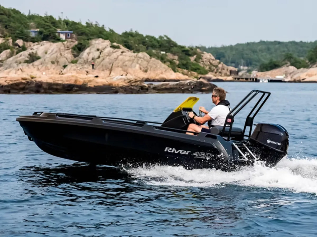A black River Hydra 460 polyethylene cruising on the sea on a sunny day.
