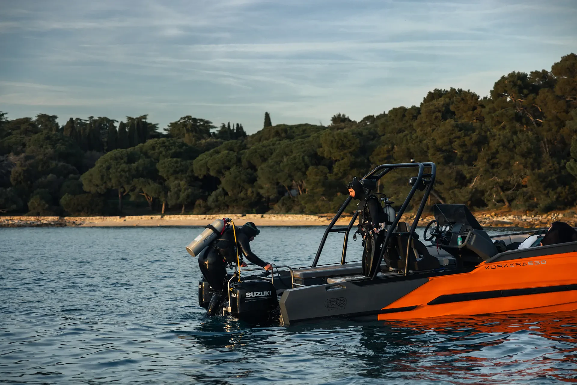 Korkyra scuba boat with a diver climbing aboard after a coastal dive.